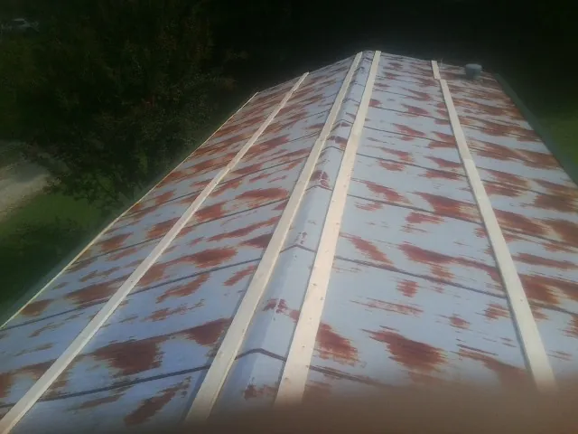 Rusted metal roof panels with new wood purlins before replacement — Storm Damage Roof Repair in Kathleen by Roofing Brothers